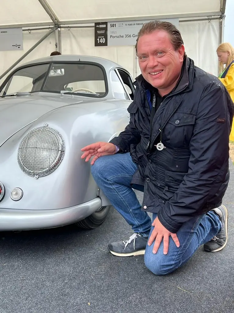 Yves den Doelder kneeling beside a silver Porsche 356